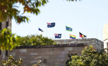 The rainbow flag flies on top of UQ's Forgan Smith building. The rainbow flag flies alongside the Australian and Aboriginal Flags on top of UQ's Forgan Smith building.